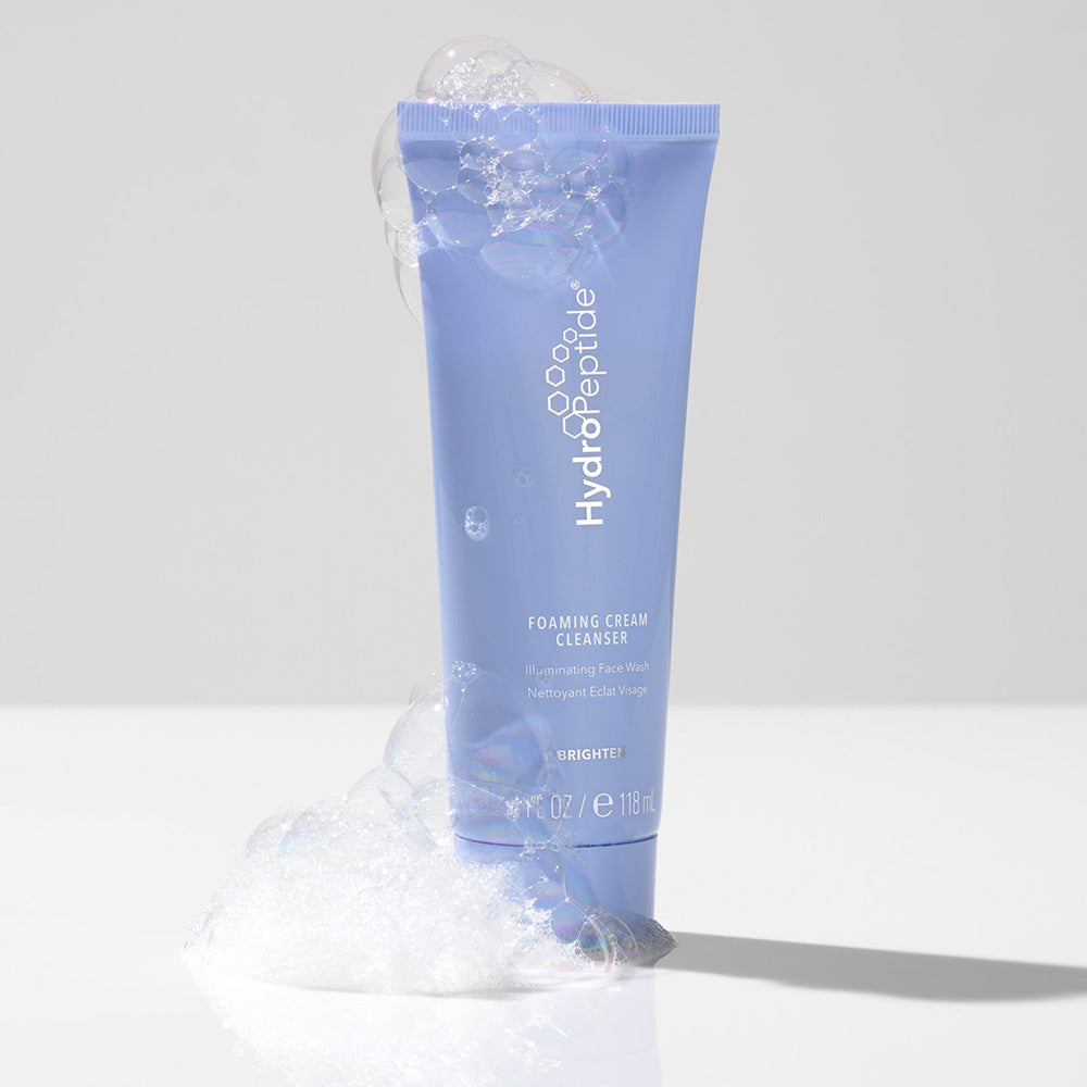 HydroPeptide foaming cream cleanser tube with bubbles on a light gray background