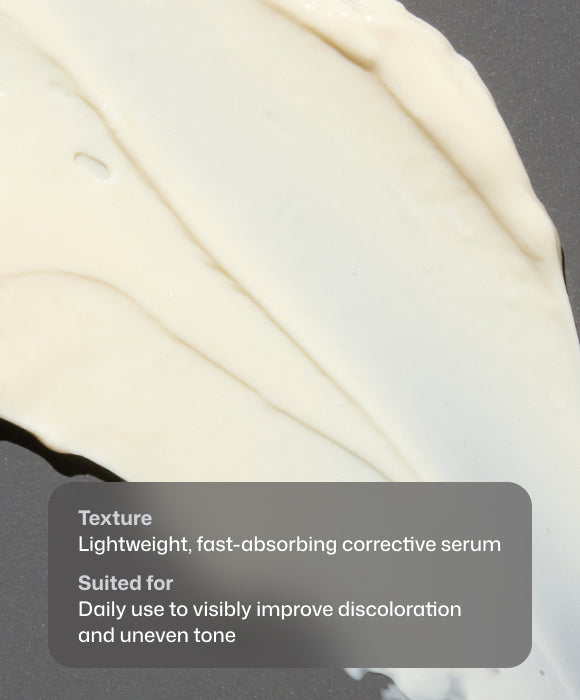 Close-up of a thick, creamy off-white cosmetic serum swatch on a dark gray surface, with a semi-transparent text box describing its texture and benefits. Revision Advanced Pigment Corrector+™ serum texture with niacinamide, vitamin C derivative, peptides, and brightening actives.