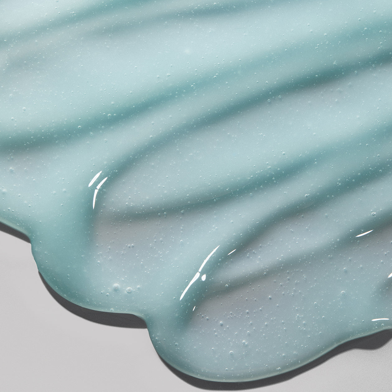 Close-up texture of Obagi ELASTIderm Neck and Décolleté Concentrate lightweight, fast-absorbing fluid, designed to tighten, hydrate, and support resilient skin.