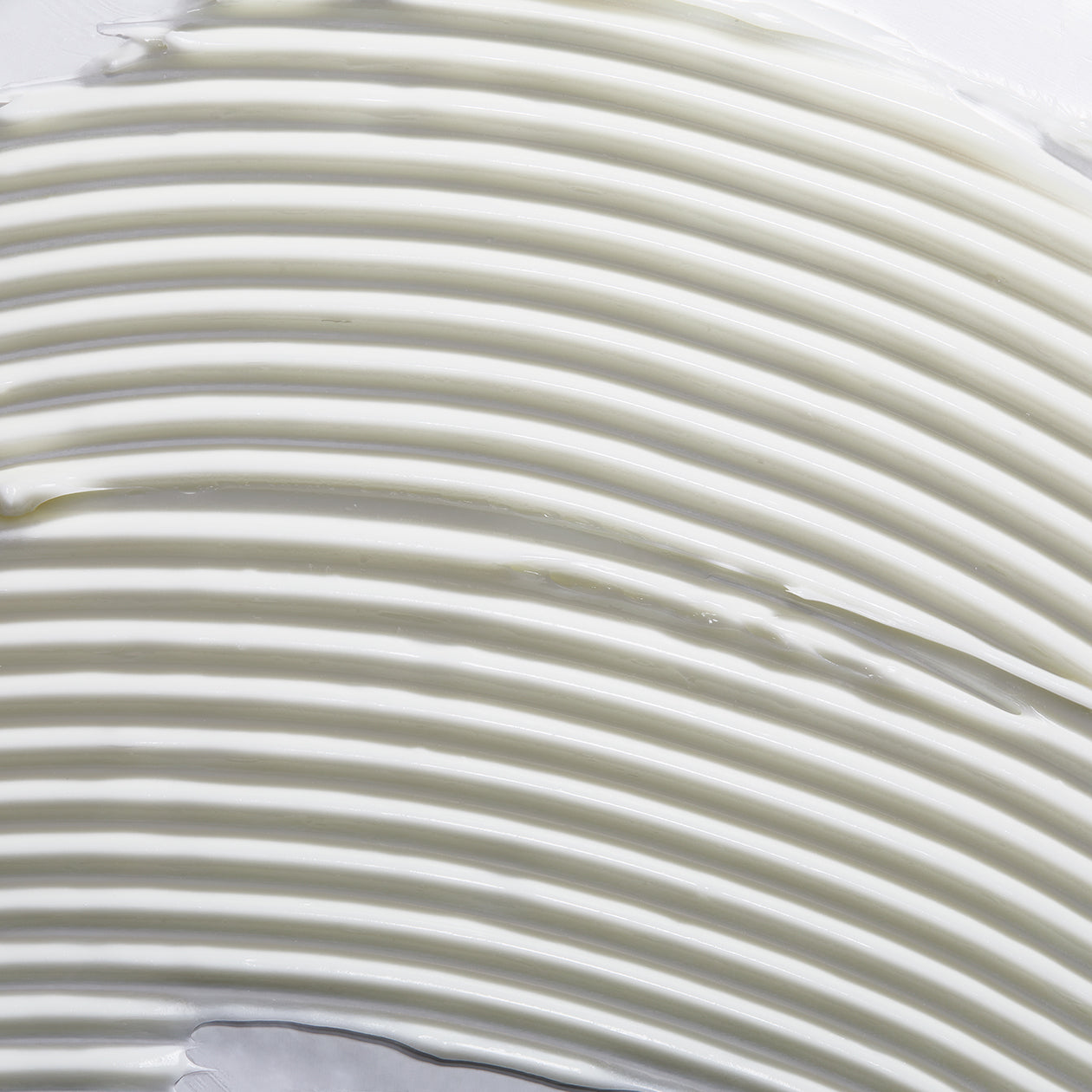 Close-up texture of Obagi Hydrate Luxe ultra-rich cream, cushiony formula for deep overnight moisture.