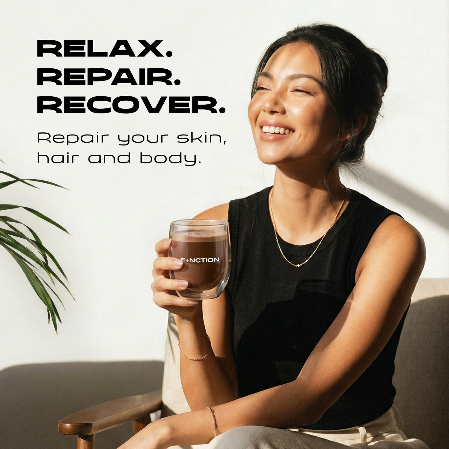 A woman in a black sleeveless top sits in a chair holding a clear glass with the word 'FUNCTION' printed on it, in a bright indoor setting with text reading 'RELAX. REPAIR.