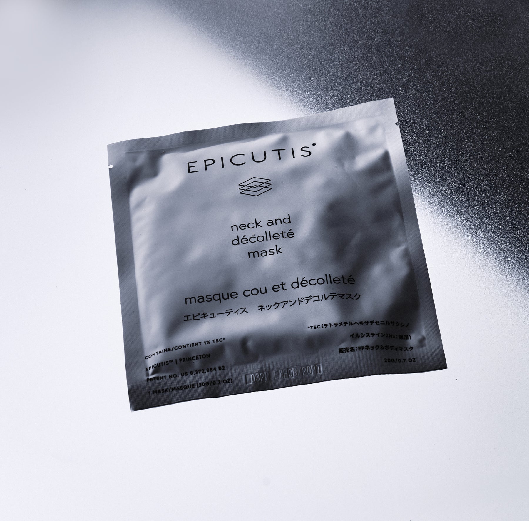 Epicutis neck and décolleté mask packaging on a reflective surface