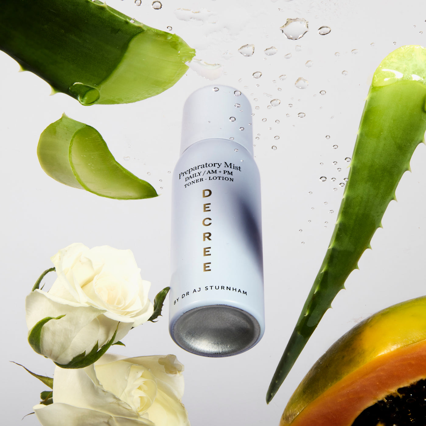 Decree Preparatory Mist fine mist texture for refreshing dry, stressed, and sensitive-looking skin. Skincare product with aloe vera leaves and roses on a light background.