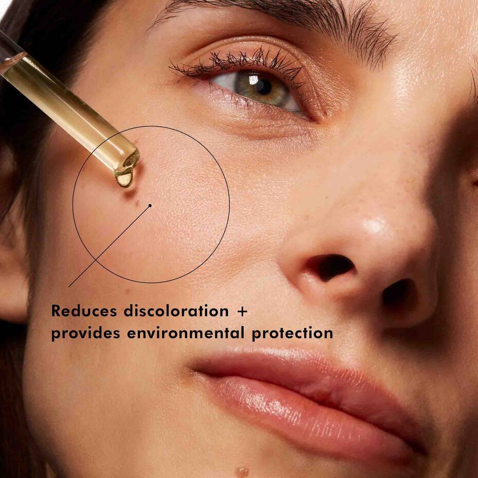 Close-up of a dropper applying SkinCeuticals Phloretin CF serum to a person's skin with text about product benefits.