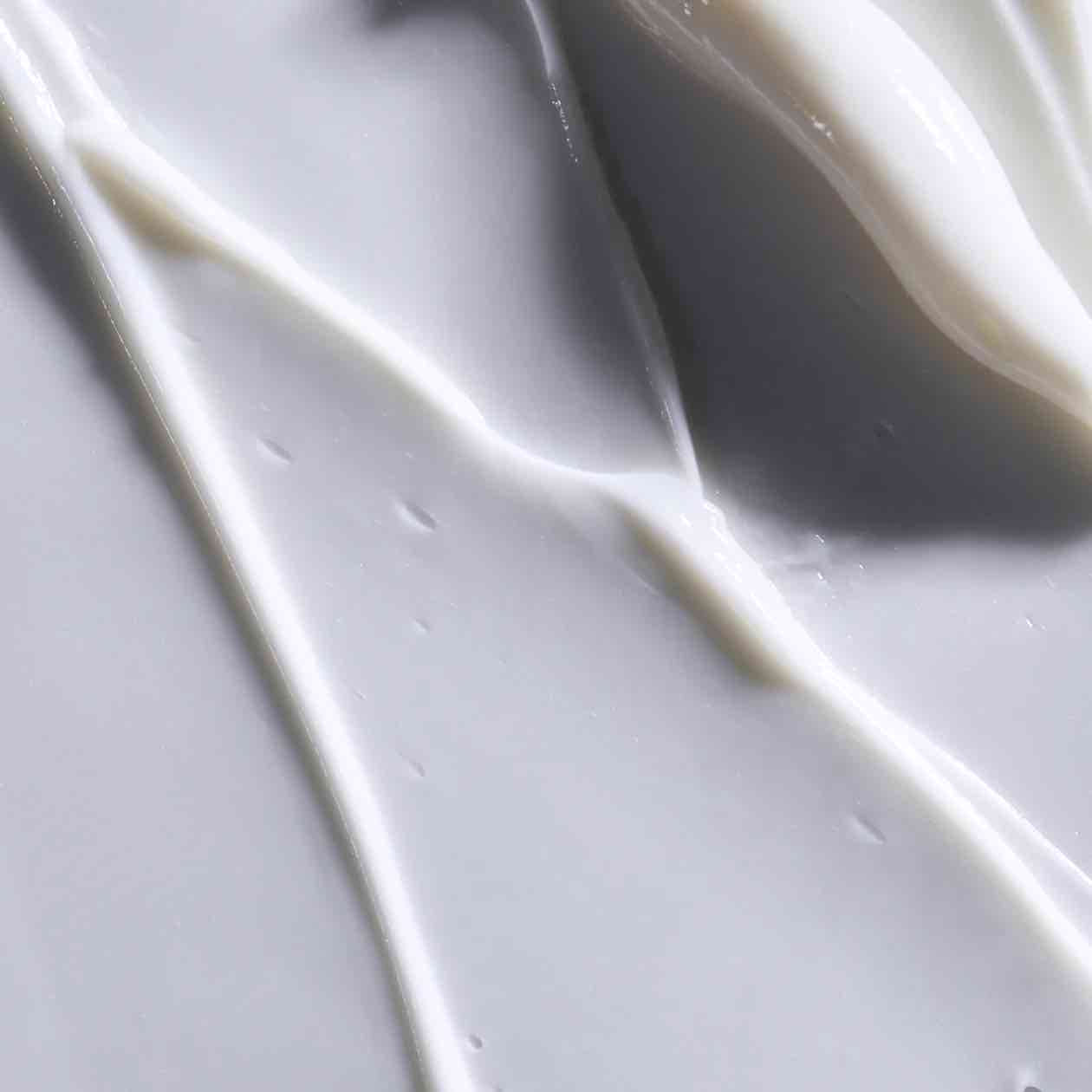 Close-up texture of Obagi Rebalance Skin Barrier Recovery Cream, rich, creamy formula for instant comfort and long-lasting moisture.