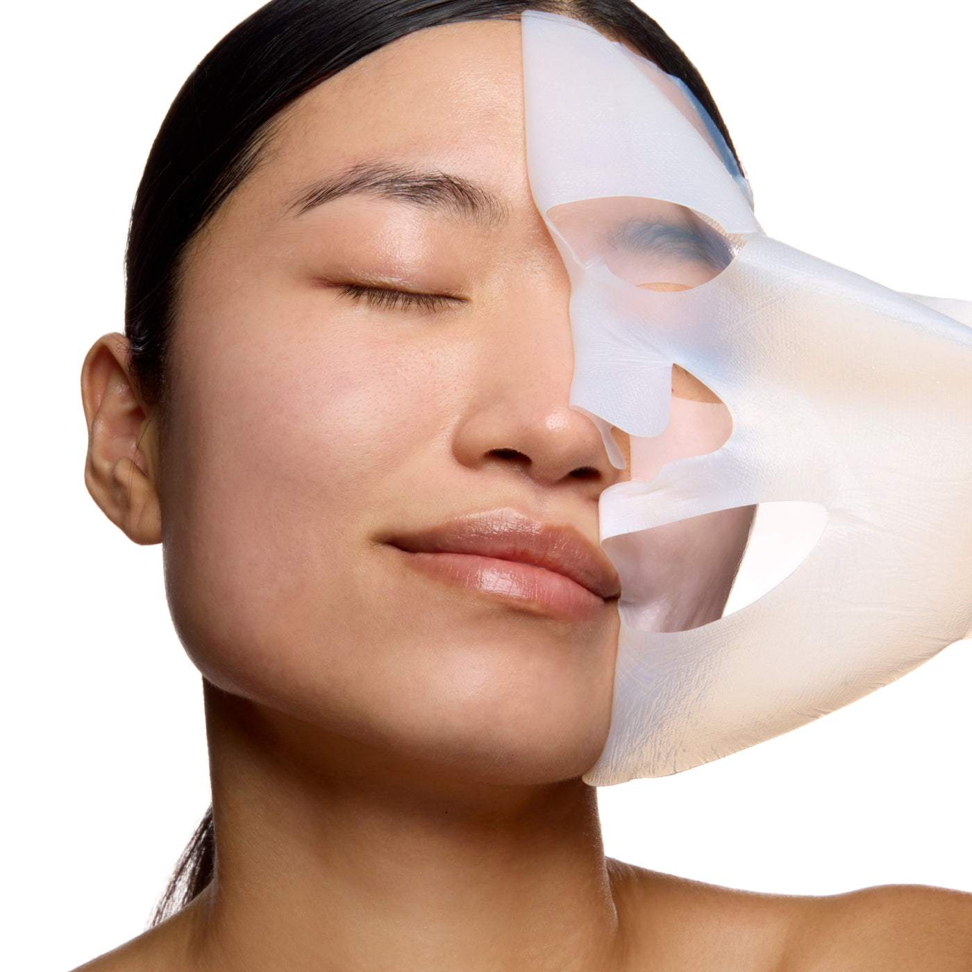 Decree SOS Revitalising bio-cellulose sheet mask applied to the face during a weekly skincare treatment. Woman with a skincare product applied to her face on a white background.