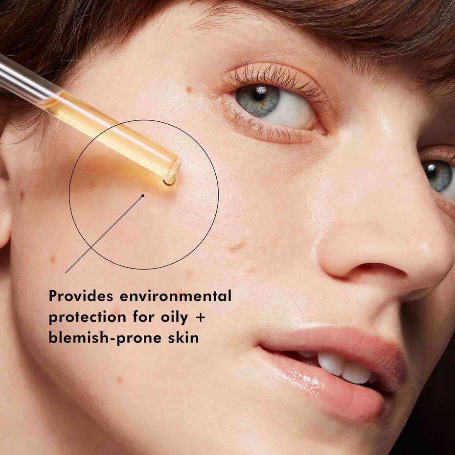 Model applying SkinCeuticals Silymarin CF—morning treatment for oil control and clarity.
