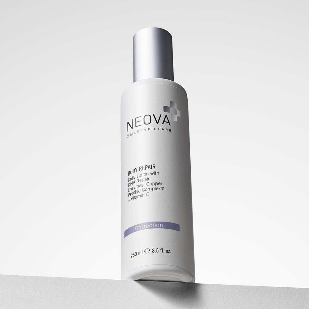 NEOVA Body Repair lotion bottle with a metallic silver cap, standing on a light gray surface against a white background. Daily body moisturiser with DNA repair enzymes and copper peptides.