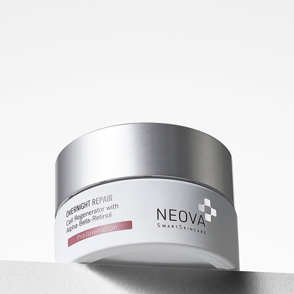 A silver and white cosmetic jar of NEOVA OVERNIGHT REPAIR Cell Regenerator with Alpha-Beta-Retinol, photographed on a clean white background with a soft shadow. NEOVA Overnight Repair jar on a clean background, overnight treatment cream with retinol and multi-acid renewal.
