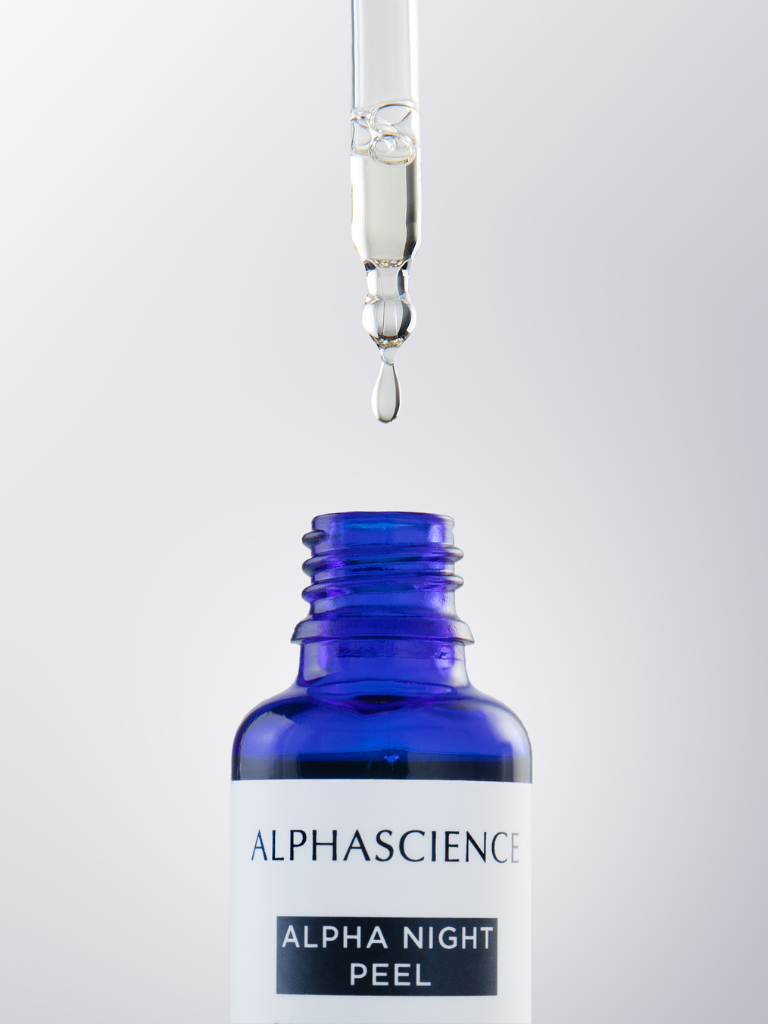 Blue bottle of Alpha Science Alpha Night Peel with a dropper on a white background