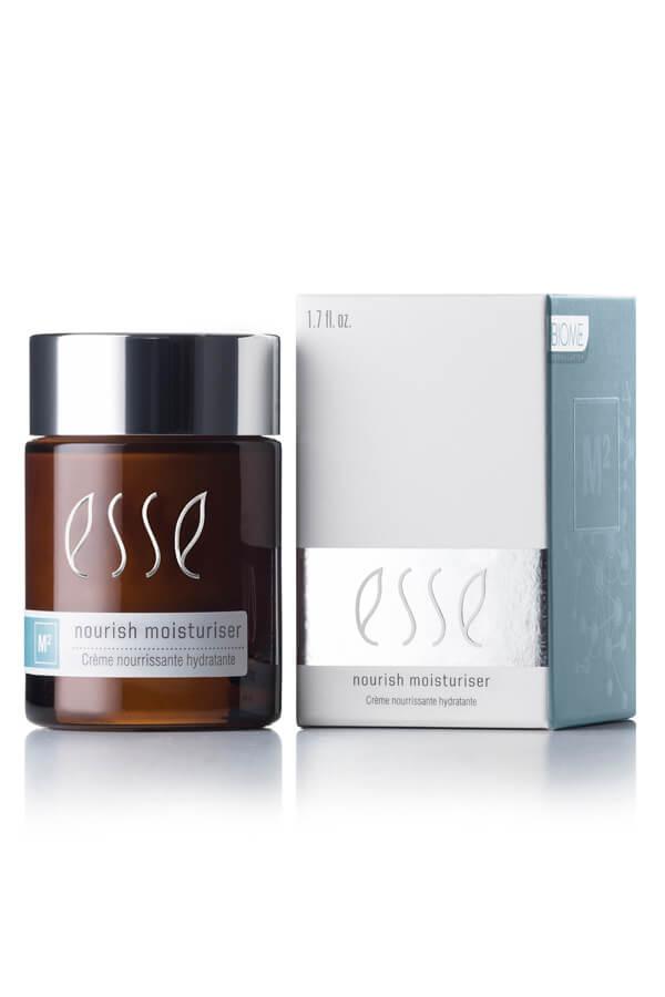 Essé Nourish Moisturiser bottle and packaging box on a clean white background. The amber glass bottle has a silver cap and white 'esse' branding, next to its white and light blue box. Esse Nourish Moisturiser rich probiotic moisturiser for dry and sensitive skin.