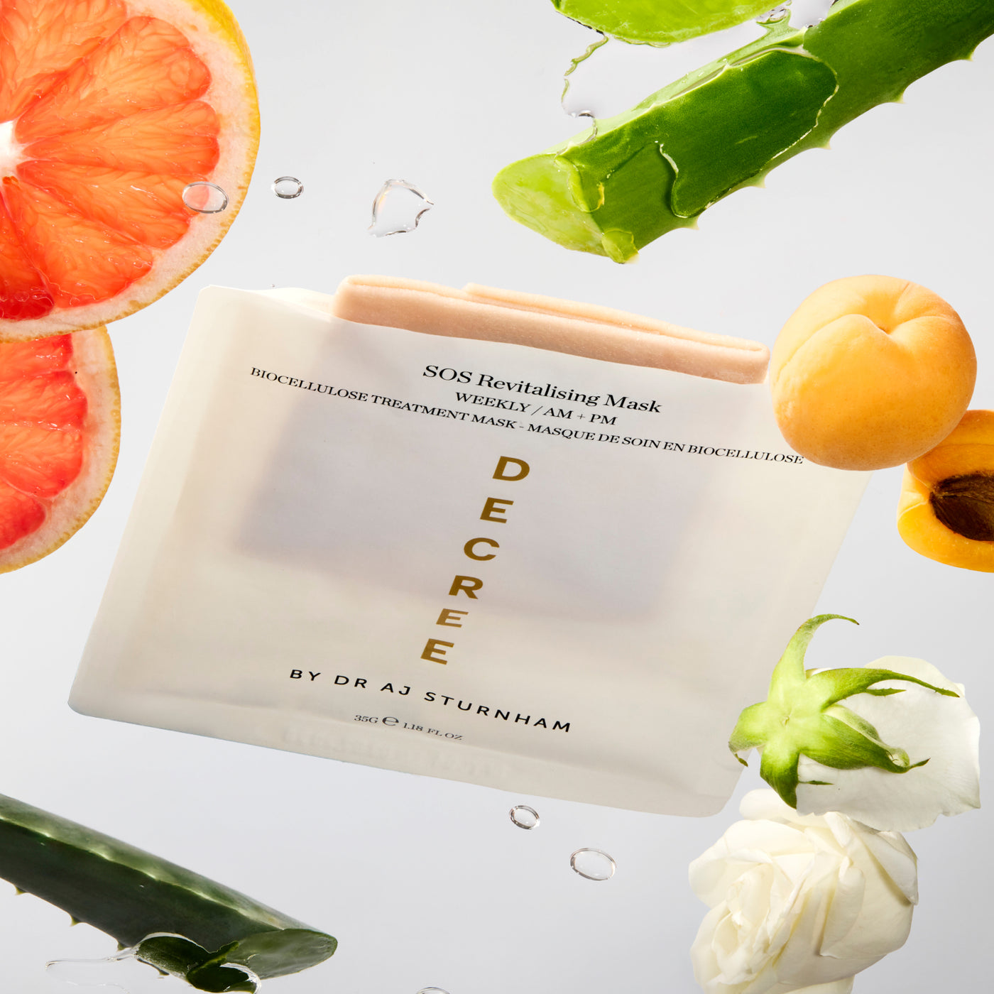 SOS Revitalising Mask by Decree with fruits and plants on a light background. Decree SOS Revitalising Mask vegan bio-cellulose sheet mask with rose water, niacinamide, and hyaluronic acid.