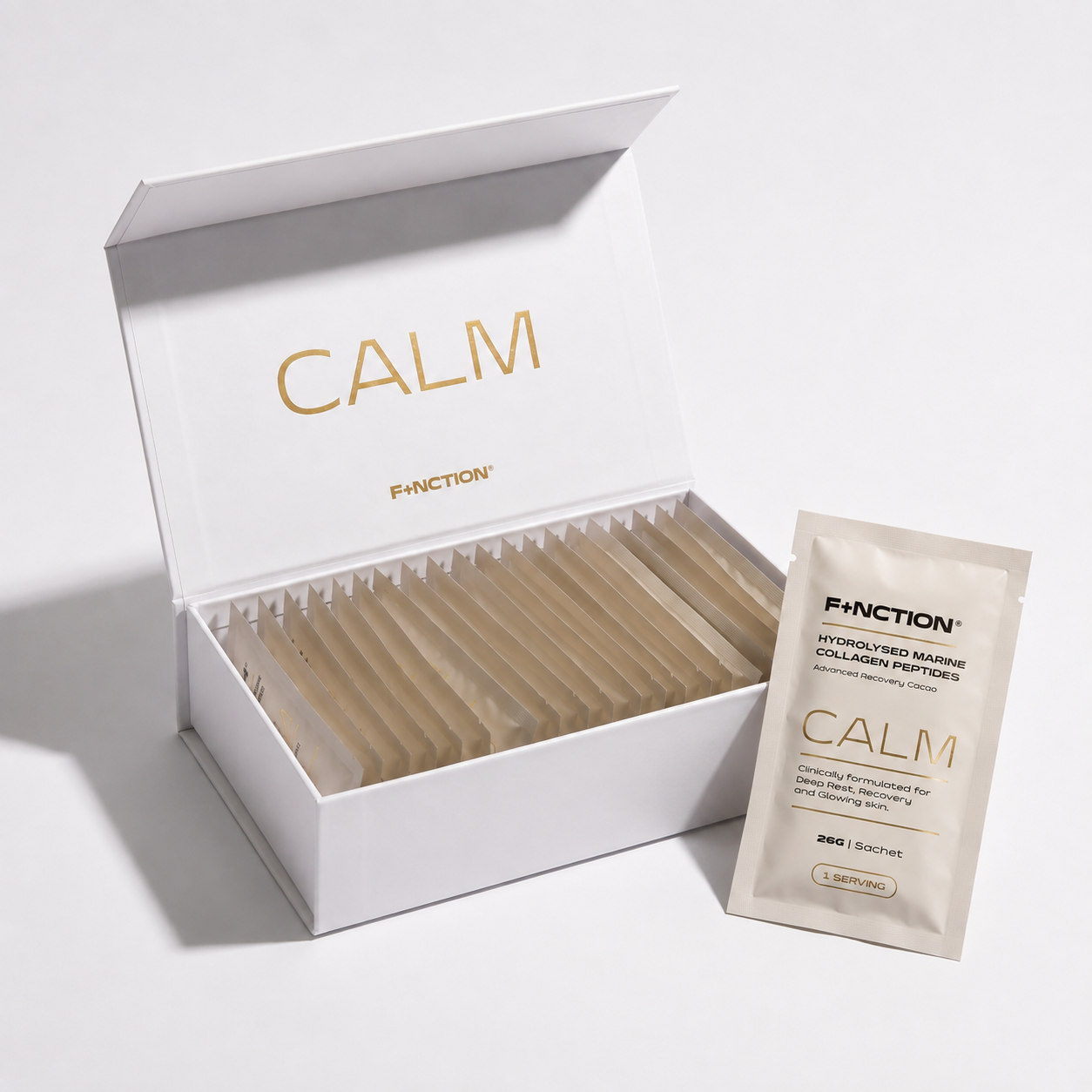 An open white FUNCTION Calm collagen powder box with multiple sachets inside, shown on a clean white background with one sachet placed beside it.
