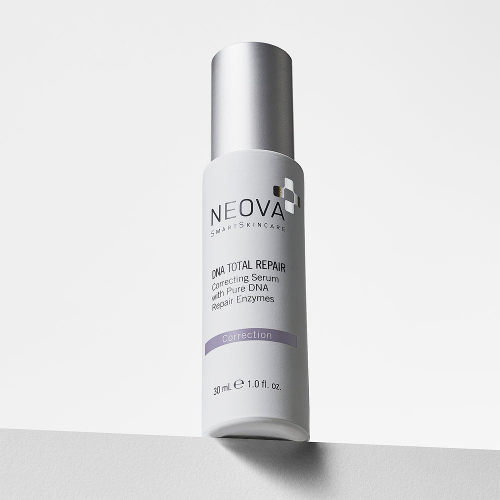 A 30 mL bottle of Neova Smile Skincare 'Correction' DNA Total Repair Correcting Serum, featuring a white bottle and silver cap, standing on a light gray surface against a white background. NEOVA DNA Total Repair serum on a clean background, a correcting treatment with three pure DNA repair enzymes.